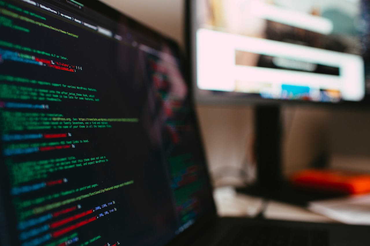 Home A detailed view of programming code displayed on a laptop screen, depicting a tech workspace.